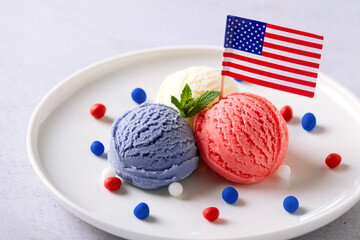 Patriotic colors ice cream scoops with American flag on white plate