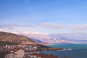 Panoramic view of Egirdir lake side mountains and town in Isparta region. Calm turquoise and scenic coast of national park in Turkey