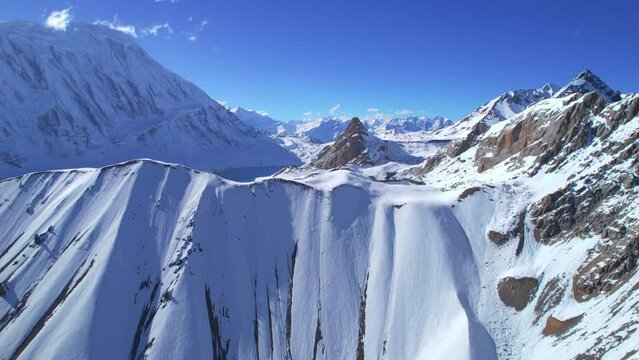 Aerial revealing view scenic breathtaking panorama of beautiful blue Tilicho lake in high altitude Himalaya mountains range. Tilicho base camp route, Nepal