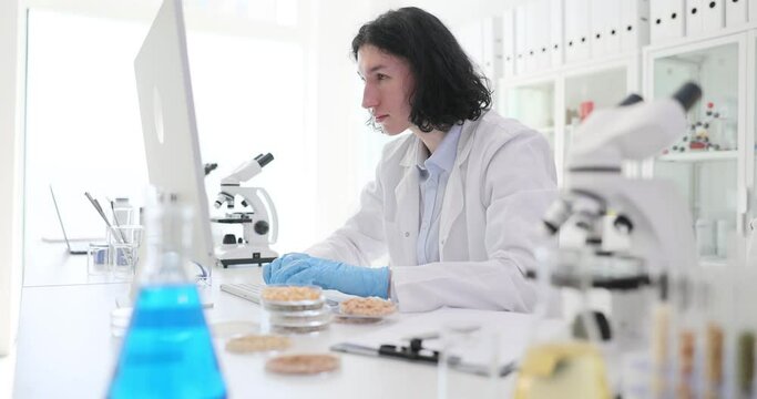 The laboratory assistant makes notes on the verification of seeds. The quality of the material for sowing, cereal