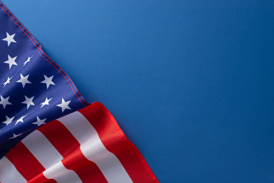 American federal holiday concept. High angle view photo of american flag on blue isolated background with copy-space