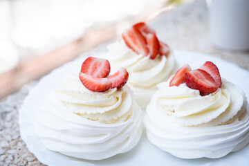 Homemade meringue dessert Pavlova cake with fresh strawberries and mint. Summer dessert. French...