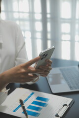 Shot of a asian young business Female working on laptop in her workstation.