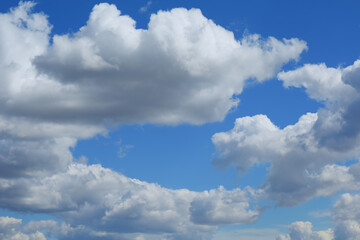 Сumulus clouds in the blue sky floating away to the horizon