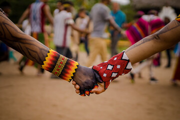 Sao Paulo, SP, Brazil - April 20 2023: People holding hands wearing traditional colorful bracelets...