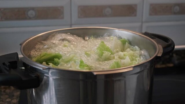 cooking healthy green vegetable, in pot, in domestic kitchen
