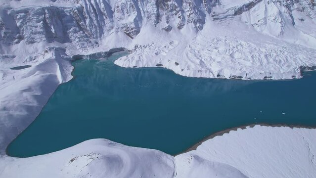 Aerial top down view blue alpine Tilicho lake in high altitude Himalayas mountains in Nepal. Manang district. Pristine highest Alpine lake in the world