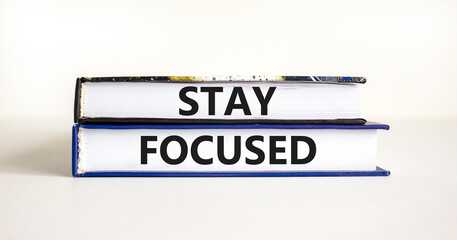 Stay focused symbol. Concept words Stay focused on beautiful books on a beautiful white table white background. Business, support, motivation, psychological and stay focused concept. Copy space.