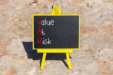 VAR Value at risk symbol. Concept words VAR Value at risk on beautiful black chalk blackboard....