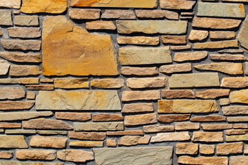 Stone texture background. Closeup of a old gray brown of a weathered concrete wall with a hilly uneven surface with natural stones. Abstract background concept.