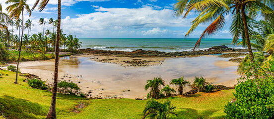 Panoramic image of Prainha, a small deserted beach surrounded by coconut trees in Serra Grande on the south coast of Bahia state