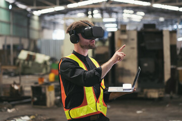 Male factory mechanic using virtual reality headset. Male engineer working or using virtual reality headset for checking machinery in industry factory and wearing safety uniform and helmet