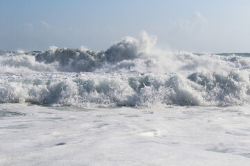 background splash white water waves isolated. wave splashing in the sea against a clear blue sky