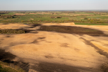 Fototapeta premium Drone photography of agricultural field and tractor tire tracks