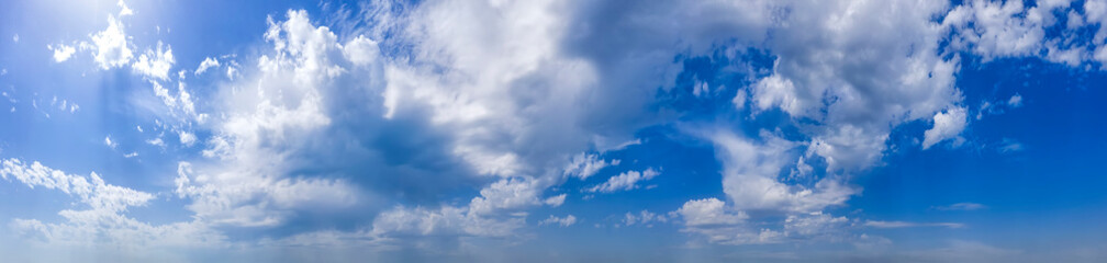 Naklejka na ściany i meble Panoramic view of blue sky with clouds.