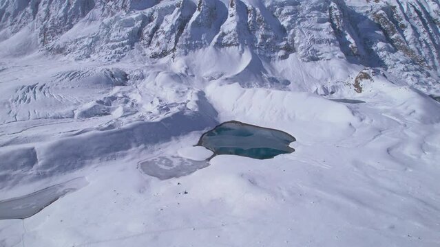 Aerial overhead view small remote alpine lakes by Tilicho lake in high Himalayas mountains in sunny winter day. Manang. Highest Alpine lakes in the world concept