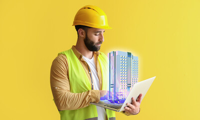 Male construction worker with laptop and new digital project of modern residential building on yellow background