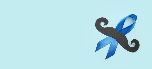 Blue awareness ribbon with paper mustache on light background with space for text