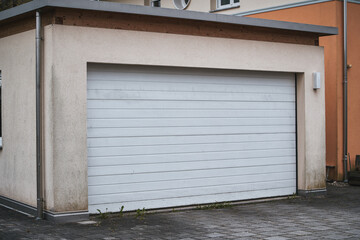 Garage concept. Closed garage doors. Exterior view of a beautiful house with garage gate.
