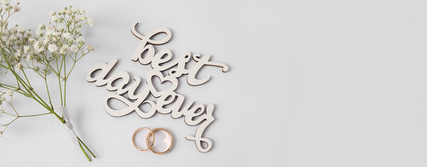 Composition with wedding rings on light background with space for text