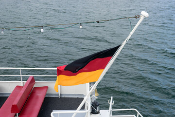 German flag on a ship at half-mast during a burial at sea