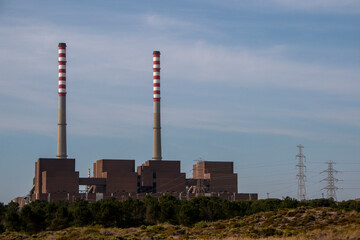 Factory producing electricity with two huge chimneys
