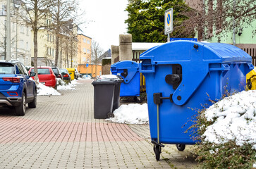 View of garbage containers in city on winter day