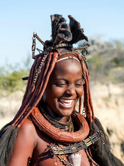 Happy Himba woman smiling, dressed in traditional style in Namibia, Africa. - 613623016
