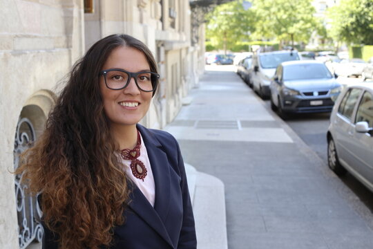 Fototapeta Beautiful elegant woman posing in city street 