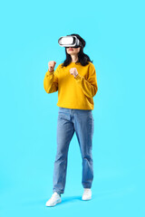 Beautiful woman using VR glasses on blue background