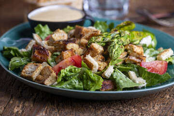 caesar salad on a green plate