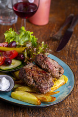 greek bifteki with salad and fries - 613626686