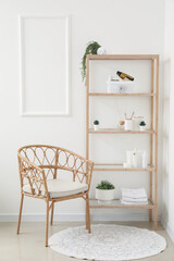 Shelving unit with bath accessories, houseplants and armchair in light room