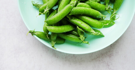 Green peas on the plate top view. Legume vegetables. Fresh crop 