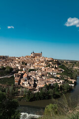 Fototapeta na wymiar Panoramic landscape with beautiful blue sky and view of the Tagus river in the city of Toledo, Spain.