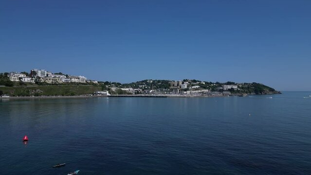 Torquay, Torbay, South Devon, England: DRONE VIEWS: The drone flies over paddleboarders before continuing across Torbay towards Torquay Marina as one pleasure boat leaves the Marina and another enters