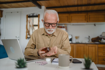 One man senior caucasian male hold medicine drugs tablet read label