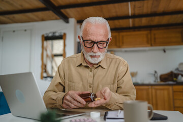 One man senior caucasian male hold medicine drugs tablet