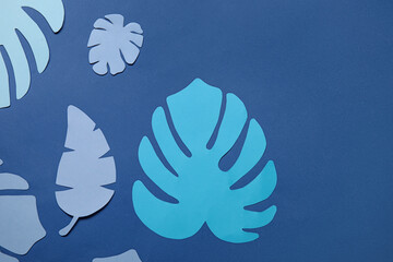 Fototapeta na wymiar Beautiful origami leaves on blue background