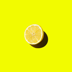 Fresh cut lemon lies on a yellow background isolate top view