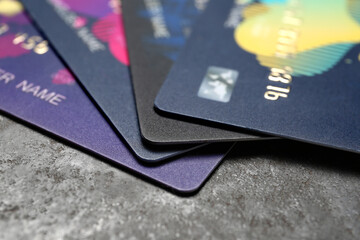 Credit cards on grey grunge background, closeup