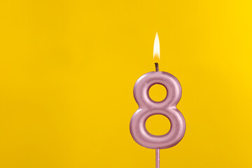 Birthday candle number 8 - Birthday celebration on yellow background