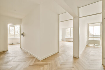 Fototapeta na wymiar an empty room with white walls and wood flooring in the middle part of the room, there is a door leading to another
