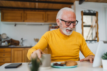 Senior caucasian man use digital tablet to make a video call at home