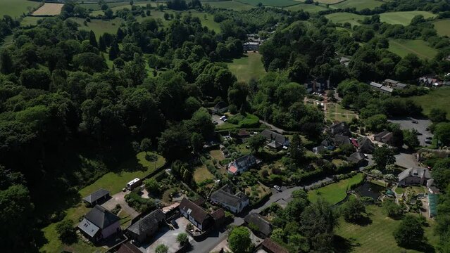 Cockington, Torquay, South Devon, England: DRONE VIEWS: Descending view of the village of Cockington and Cockington Court manor house (top centre of picture) and cricket pitch.