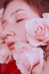 Pink portraits of a young girl with red roses on her face