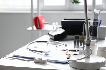 Doctor's workplace with medical supplies in office, closeup