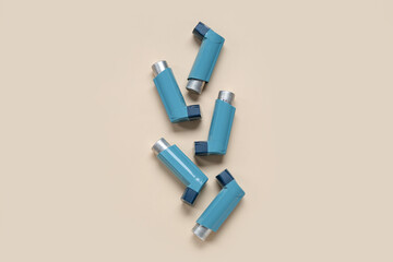 Asthma inhalers on beige background
