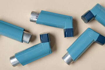 Asthma inhalers on beige background