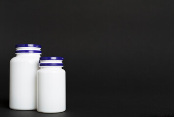 Plastic bottles for vitamins on color background